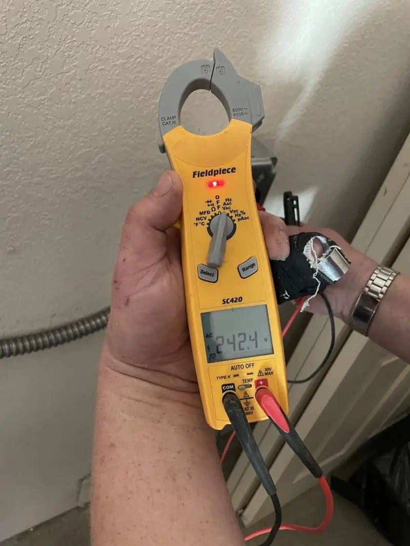 Voltage testing with clamp meter during Outlet Installation in Chilton